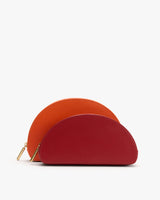 Two semicircular pouches with zippers, one slightly larger and behind the other.