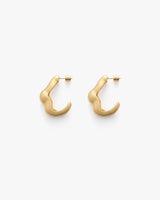 Pair of curved, minimalist earrings displayed on a plain background.