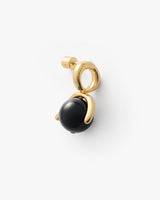 Gold earring with geometric design and black stone.