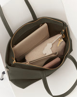 Open tote bag with a wallet, pouch, and keys inside.