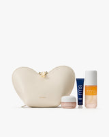 Heart-shaped pouch with skincare products in jars and tube.