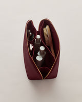 Open toiletry bag with various grooming items inside