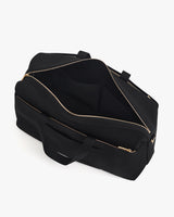 Open travel bag with visible zippers and handles.