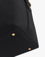 Corner of a travel bag with metal studs