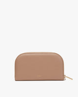 Leather half-moon zip wallet on a plain background.