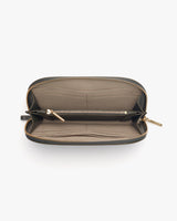 Open wallet with zipper compartments on a light background.
