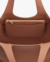 Open handbag with an attached small zipper pouch.
