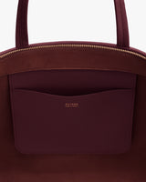 Open handbag with interior pocket and gold zipper detail