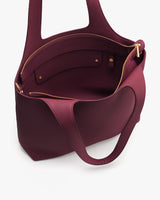Open tote bag with a zippered pocket inside and handles.