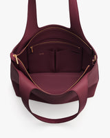 Open travel bag showing interior compartments and a zipper pocket.