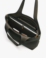 Open travel bag with laptop and other items inside.