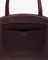 Open handbag with visible interior pocket and zipper.