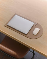 Laptop and mouse on a flattened laptop sleeve.