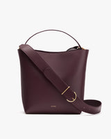 Bucket bag with a handle and adjustable shoulder strap.
