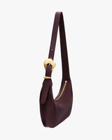 Shoulder bag with zipper and adjustable strap, featuring a metal buckle loop.