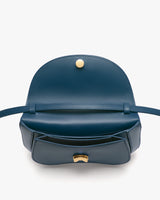 Open handbag with flap and button clasp, showing interior.