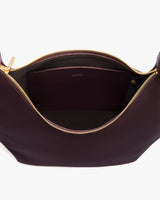Open handbag with visible zipper and inner pocket.