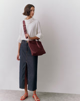 Person wearing a shoulder bag cross body with strap
