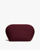 Oval-shaped pouch with a zipper on a flat surface