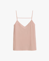 Camisole top with thin straps and a V-neckline hanging on a hanger.