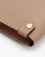 Close-up of a handbag with a metal clasp