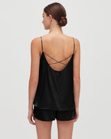 Woman from behind wearing a strappy top with criss-cross design on the back.
