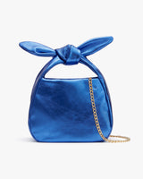 Small handbag with a tied top knot and chain strap.