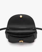 Open handbag showing interior and clasp details.