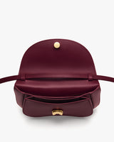 Open handbag with front pocket and clasp on display