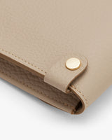 Close-up of a handbag with a metallic snap closure.