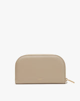 A domed zippered pouch with a brand name on the front.