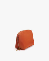Small zippered cosmetic bag standing upright