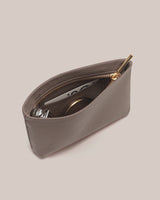 Open pouch with zipper, containing a card, perfume and a compact mirror.