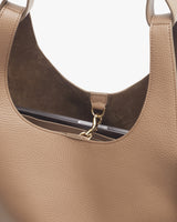 Top inside part of a handbag showing clasp and stitching details.