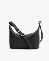 A small handbag with an adjustable strap and zipper closure.