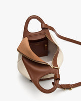 Open handbag with visible interior pocket and gold zipper on a white background.