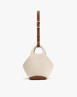 Handbag with a round handle and adjustable shoulder strap.