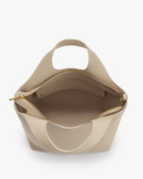 Open handbag with a zipper and interior pocket visible.