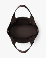 Open empty handbag with wide straps and buckle details seen from above.