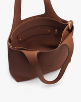 Open tote bag with handles and pockets inside.