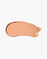 Cream eyeshadow smear on a plain background.