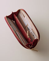 Open wallet with multiple compartments and a zipper.