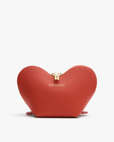 Heart-shaped pouch with zipper and embossed text on front.