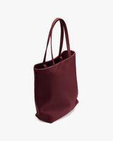 Tote bag with two handles viewed from an angle.