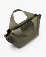 Handbag with large handles and open pocket design.