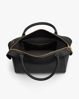 Open handbag with visible interior and a small pocket.