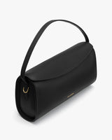 Handbag with a curved flap and a short strap.