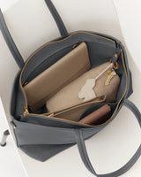 Open tote bag containing a wallet, pouch, and a set of keys.