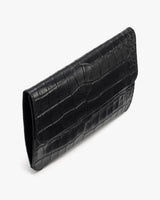 Rectangular clutch with croc-embossed leather texture.