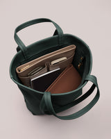 Tote bag filled with a laptop, notebook, and small organizer.